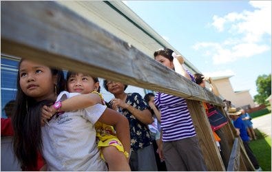 Suzanna Thach, 9, and Jina Kim, 4, were among those waiting last week to receive supplies from a food bank in Bayou La Batre. The girls, from Irvington, Ala., are children of out-of-work crabbers.