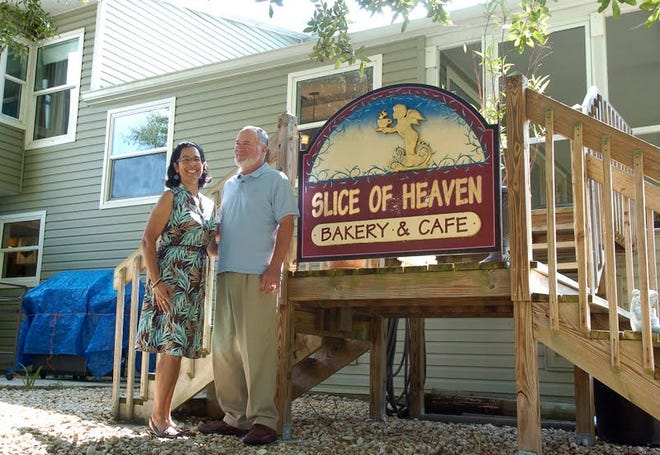 Nadia and Charley Oliver in their backyard. The sign is from a Rhode Island bakery Nadia once owned.