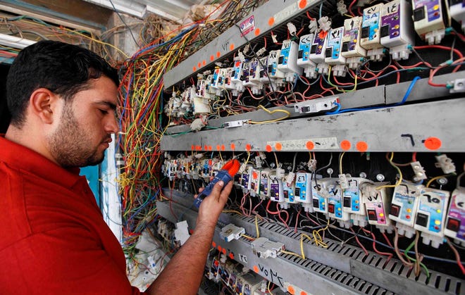 Abbas Ahmed works on a generator during a power outage in Baghdad last week. 
Baghdad residents are obsessed with the thousands of generators around the 
city that they rely on for electricity because the national power grid is so 
notoriously unreliable.ASSOCIATED PRESS / HADI MIZBAN