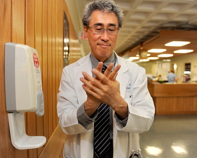 Infectious disease physician Dr. Chinhak Chun at a handwashing station