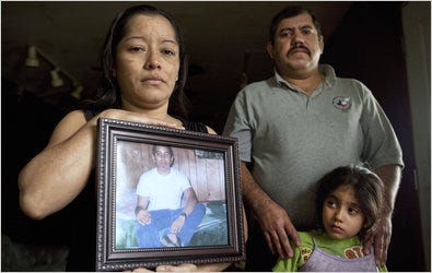Rosa Payesa and Carlos Zaldivar with a photograph of their son, Benito Zaldívar, who was killed in his native El Salvador after being denied asylum and deported from the United States. He had lived with his parents in Carthage, Mo., with his sister, Beatris.