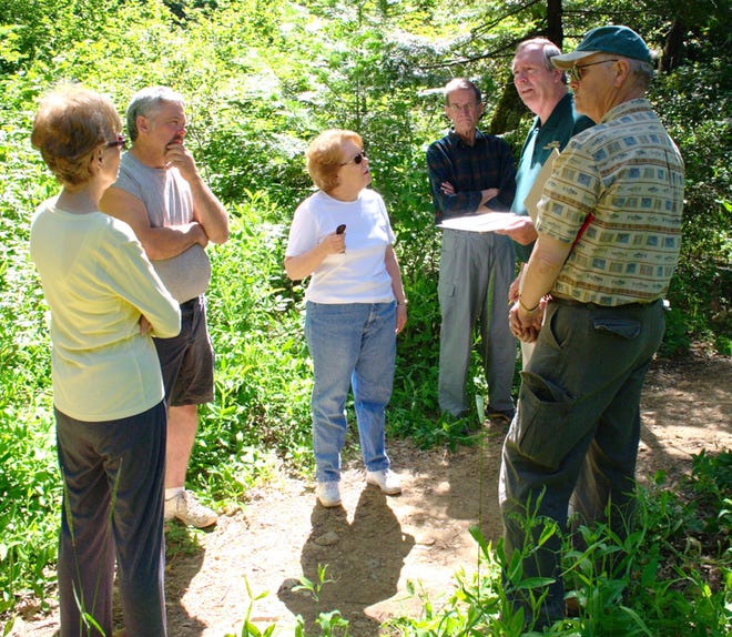 Senior grants specialist Bruce Irwin, second from right, discusses grant-funded project administration Friday with community representatives on a path near the park amphitheater, site of a proposed Dunsmuir Nature Center project. He said that if the grant is accepted, 25% of the $3 to 7 million will go into project management, a task councilman Mario Rubino, second from left, wanted undertaken by someone other than the city. Others listening were, left to right, DBG members Harriet Alto and Judy Harvey, Carl Alto, and River Exchange board member Chris Stromsness.