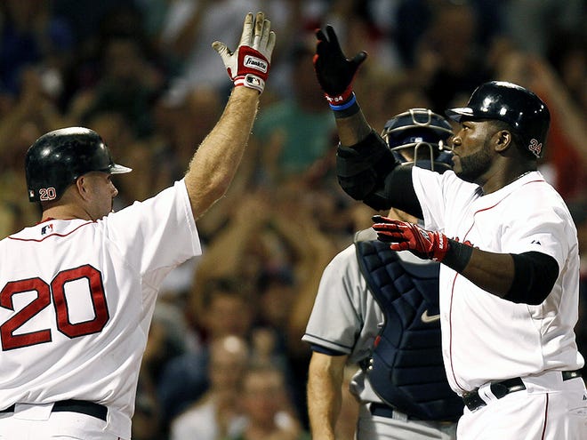 Boston Red Sox's David Ortiz, left, is greeted at home by teammate Kevin Youkilis after he hit a three-run home run against the Tampa Bay Rays during the fifth inning of a baseball game at Fenway Park in Boston Tuesday, June 29, 2010. (AP Photo/Winslow Townson)
