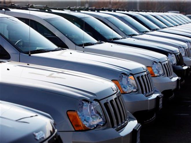 In this March 7, 2010 file photo, 2010 Jeep Grand Cherokees sit at a Chrysler Jeep dealership in Centennial, Colo. Chrysler Group LLC says its sales slid about 12 percent from May to June as worries about the economy weighed on consumers.
