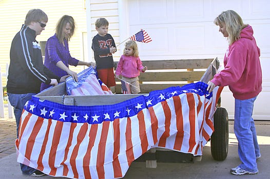 This week, staff members of the Federal Employees Credit Union and other volunteers got to work on their Fourth of July parade float at the Oshelski home in Sault Ste. Marie. Pictured are (from left) Andrew Miller, Sabrina Oshelski, five-year-old Carter Oshelski and his two-year-old sister Ahnaka, and Dawn Cole. The parade begins at 8 p.m. Sunday evening.
