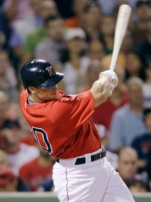 Red Sox pinch hitter Daniel Nava follows through on his RBI single, breaking a 2-2 tie, against the Baltimore Orioles during the eighth inning of the baseball game at Fenway Park in Boston, Friday, July 2, 2010.