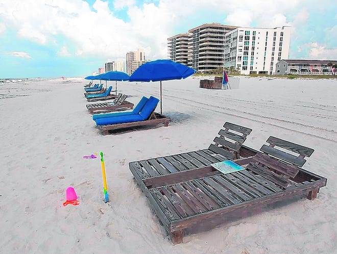 Empty chairs line the beach in Perdido Key on Friday, a day that is 
typically the opening of the busiest tourist weekend of the year for coastal 
towns in the Panhandle.