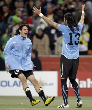 Uruguay's Edison Cavani (left) and Sebastian Abreu celebrate after the World Cup quarterfinal soccer match between Uruguay and Ghana at Soccer City in Johannesburg, South Africa, on Friday.