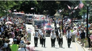 Photos by Amy Paterson/New Jersey Herald  Hundreds watch as the Sparta Township Fire Department marches through White Deer Plaza in Sparta’s Independence Day Parade on Sunday. The annual parade was held under sunny skies, followed by a day-long concert at Dykstra Park.