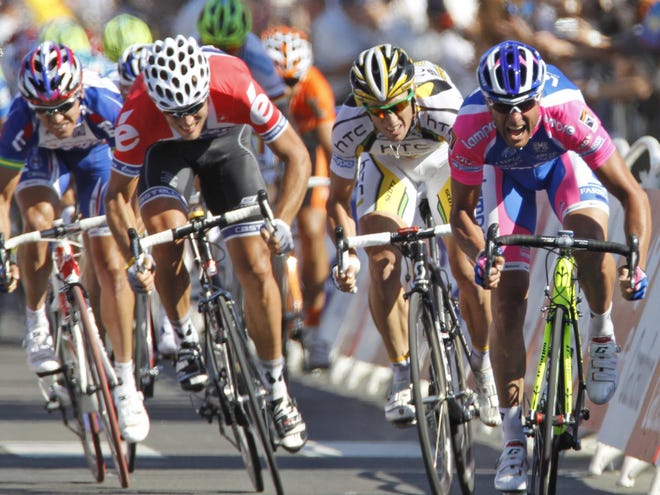 Alessandro Petacchi of Italy, right, crosses the finish line to win the first stage of the Tour de France cycling race over 223,5 kilometers (139 miles) with start in Rotterdam, Netherlands and finish in Brussels, Belgium, Sunday July 4, 2010, ahead of Mark Renshaw of Australia, second right and second place, Thor Hushovd of Norway, second left and third place and Robbie Mc Ewen of Australia, far left and fourth place.