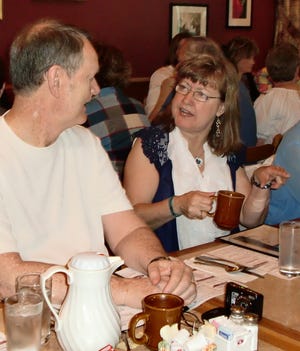 Kathy Bowen Sebring of Norfolk talks with newfound distant cousin Humphrey Hughes of Houston, Texas, as 20 members of the family gather for breakfast at Gourmet Decisions in Natick. Family members agreed Hughes looks exactly like Sebring's brother, Brian Bowen, who was not able to attend the Friday morning reunion.