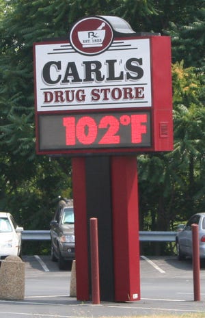 The temperature recorded at Carl's Drug Store on Wednesday July 7, was a little higher than that of weather observer Robert Wertime, who logged 100 degrees in his books. Wertime attributed the difference to a heat island created when a thermometer is near paved surfaces such as concrete, macadam or brick. The manmade materials absorb and retain heat. The effect on a broader scale means that large cities tend to be warmer than rural areas, though they are exposed to the same weather conditions.