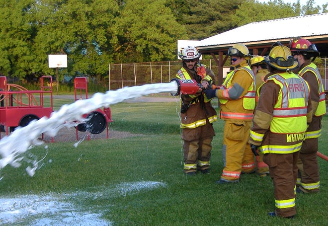 Members of the Earlville Fire Department demonstrate a new foam generating nozzle for members of the Sherburne Rotary Club. The recently acquired equipment, including two nozzles and a foam inductor, was purchased with a grant from Rotary District 7170 and the Sherburne Rotary Club.