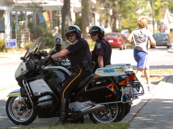 Wilmington police officers on motorcycles watch for speeders on Wrightsville Avenue.