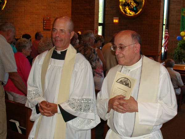 The Rev. James Pallardy, left, vicar of the Henry-Kewanee Vicariate and the Rev. Michael Pakula of St. Malachy?Church exit the sanctuary following a dedication service on July 2.