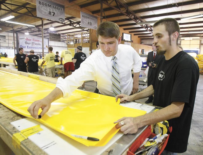 U.S. Rep. John Boccieri talks with Stanwood Boomworks employee Michael Brelo about his job on the production line.