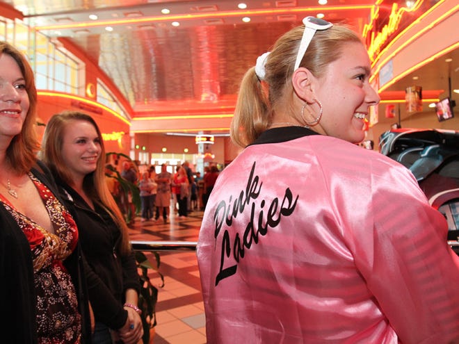 Amanda Dunbar wears her Pink Ladies jacket as she stands in line with other people while waiting for the start of the first Grease Sing-A-Long movie at the Regal Entertainment Hollywood 16 on Southwest 27th Avenue in Ocala, Fla. on Thursday, July 8, 2010. The movie showing was the first of six sold out shows at the theater where John Travolta bought popcorn for all ticket holders.