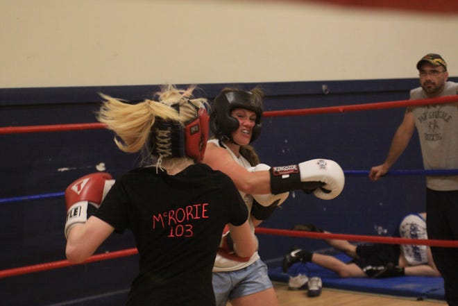 Kayla McRorie, left, and Andrea Fitzpatrick, right, exchange punches during a sparing session at the Torque Gym. Both girls have scheduled boxing bouts in Alma this weekend.