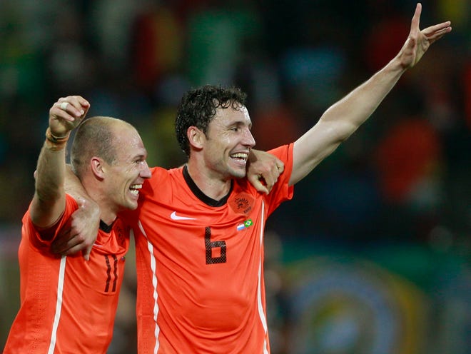 Arjen Robben (left) and Mark van Bommel (right) celebrate following the Netherlands' World Cup quarterfinal victory.