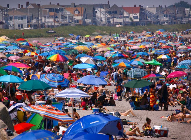 People cram for a piece of sand Monday, July 5, on Nantasket Beach in Hull.