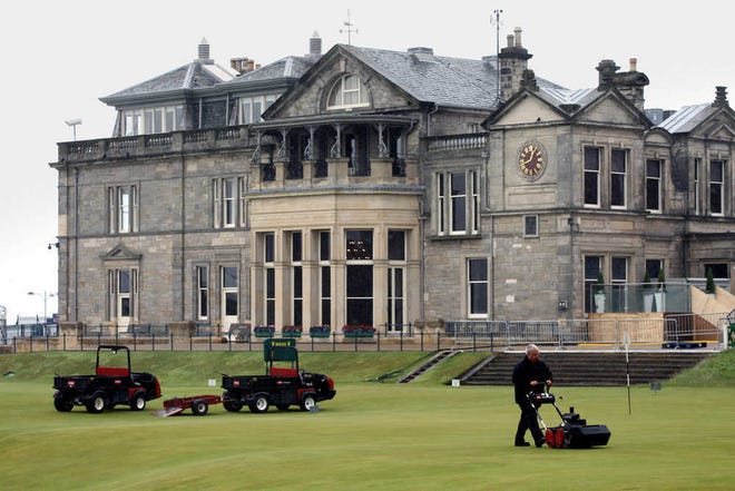 ** CORRECTS TO 150TH BRITISH OPEN ** A green keeper cuts the grass on the 18th at the Old Course, St Andrews, Scotland, Saturday, July, 10, 2010. The 150th British Open starts at St. Andrews, Scotland on Thursday July 15, 2010. (AP Photo/Peter Morrison)