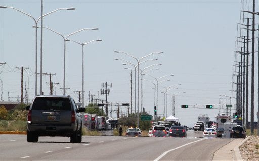 Albuquerque police cordon off an intersection near solar and fiber optic manufacturer Emcore Corp. in Albuquerque, N.M., on Monday, July 12, 2010. Police said a man entered the building and shot nine people, five of whom died. Police said the gunman was found dead inside the building of a self-inflicted gunshot wound.