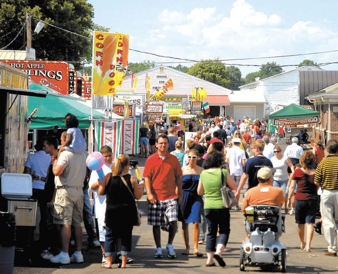People walk down the midway at the Italian-American Festival at the Stark County Fairgrounds on Sunday afternoon, the final day of the 24th annual event.