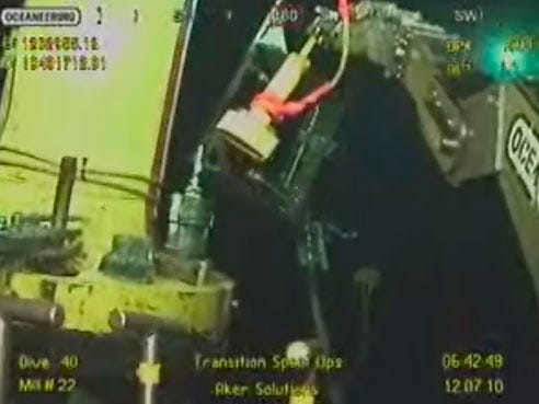In this image taken from video provided by BP PLC, a robotic arm on a remotely operated vehicle, right, tightens bolts on the transition spool, top left in yellow, which went into the gushing wellhead Sunday and will house the new containment cap, at the site of the Deepwater Horizon oil spill in the Gulf of Mexico, Monday, July 12, 2010.  (AP Photo/BP PLC) NO SALES