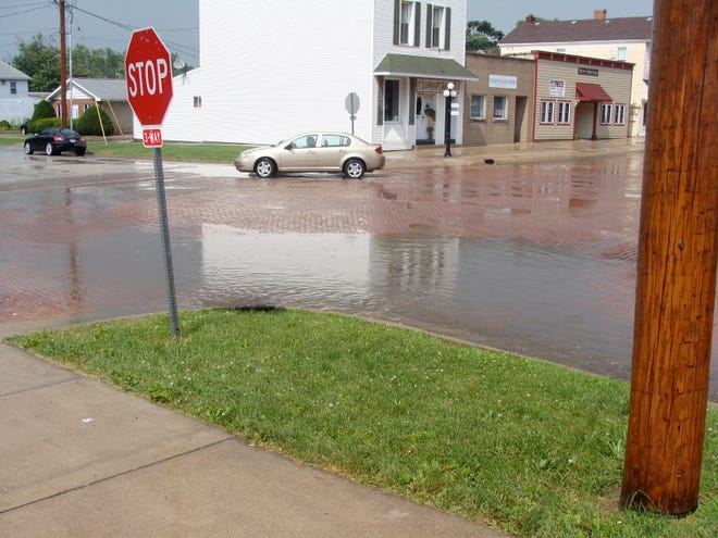 Storm water runoff pools at Menard and Partridge in Metamora following a heavy downpour July 6. The village was hit by two sustained heavy downpours within just a matter of hours that afternoon.