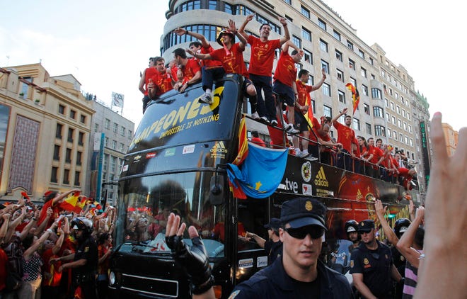 Xavi Hernandez, center right, and David Villa, center left, sing as the team parades through Madrid's Gran Via on Monday, July 12, 2010. Spain won the World Cup after defeating the Netherlands 1-0 on Sunday.
