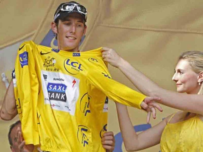 NEW OVERALL LEADER Andy Schleck, left, puts on the yellow jersey at the podium after the ninth stage of the Tour de France was completed on Tuesday.