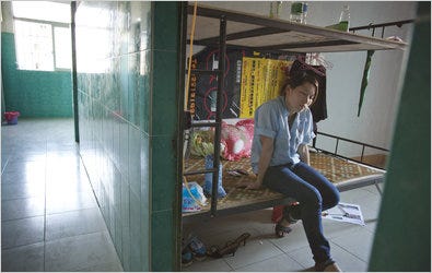 Liang Yali sat in the dormitory for her company, Guangdong Mingmen Locks Industry, in Xiaolan, Guangdong, China.