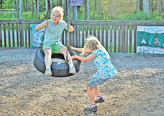 Twin sisters Katie and Ellie Marger, age 8, of Sault Ste. Marie, had lots of fun on the tire swing at Project Playground on Monday.