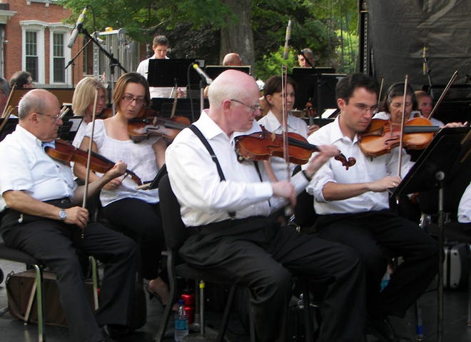 The Syracuse Symphony’s violin section was just a small portion of the group that braved the heat and humidity to provide an evening of entertainment to music lovers in downtown Hamilton on July 8.