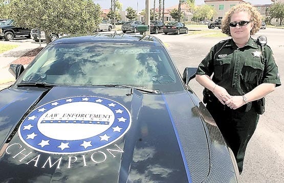 St. Johns County Sheriff's Cpl. Robin Juratovac stands next to the 2010 Chevrolet Camaro she won for the sheriff's office at the Florida Law Enforcement Challenge on Friday. Photos by PETER WILLOTT, peter.willott@staugustine.com