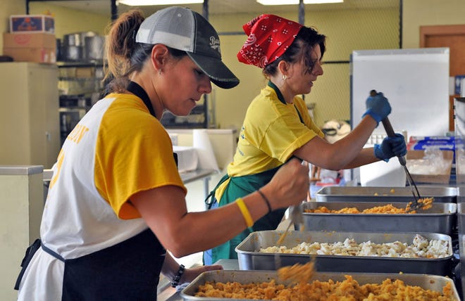 Shelly Valdivia, left, and Jackie Guerrero, two of three women dubbed "The Frijole Trinity" on the Topeka Fiesta Mexicana food committee, fry and spice potatoes for enchiladas Wednesday. The third food committee chairwoman is Celia Vega.