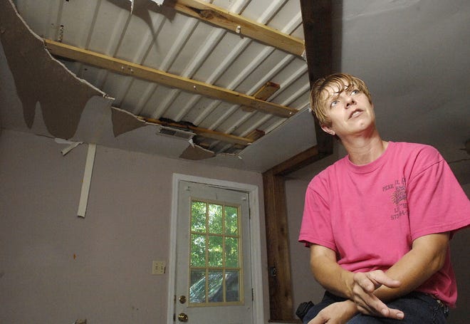 Lisa Henneberry talks Tuesday about the damage to her home on Route Z after a Sunday lightning strike.