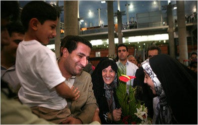 The Iranian scientist Shahram Amiri, with his 7-year-old son, was met by family members in Tehran on Thursday.