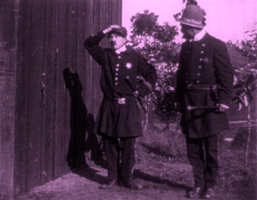This undated black-and-white video image provided by Paul Gierucki, shows a scene from the 1914 Charlie Chaplin film "A Thief Catcher," once thought lost but that will be shown publicly Saturday at an Arlington, Va., silent comedy film festival. Chaplin makes a funny cameo as a Keystone cop. Film historian and collector Paul Gierucki found the film at a Michigan antique sale late last year. (AP Photo)
