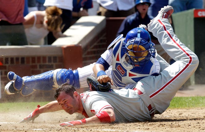 Philadelphia Phillies' Brian Schneider is safe at home as the ball gets away from Chicago Cubs catcher Geovany Soto during the ninth inning of a baseball game Saturday, July 17, 2010 at Wrigley Field in Chicago.The Phillies scored four in the ninth winning 4-1.(AP Photo/Charles Rex Arbogast)