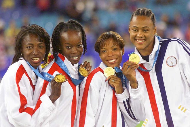 FILE - This Sept. 30, 2000, file photo shows members of the U.S. women's 4X400 relay team, from left, Jearl Miles-Clark, Monique Hennagan, La Tasha Colander-Richardson (now Colander Clark) , and Marion Jones displaying their gold medals during award ceremonies at the Summer Olympics in Sydney, Australia. American sprinters who were stripped of their 2000 Olympics relay medals because teammate Marion Jones was doping have won an appeal to have them restored. The Court of Arbitration for Sport on Friday, July 16, 2010, ruled in favor of the women, who appealed the International Olympic Committee's decision to disqualify them from the 2000 Sydney Olympics. (AP Photo/Lionel Cironneau, File)