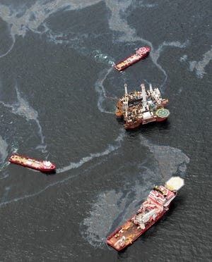 Workboats operate near the Transocean Development Drilling Rig II at the site of the Deepwater Horizon incident in the Gulf of Mexico
Friday, July 16, 2010. The wellhead has been capped and BP is continuing to test the integrity of the well before resuming production.