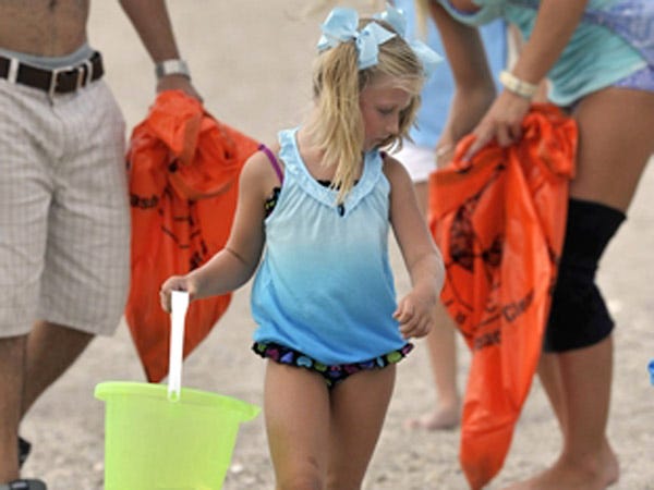 Kirra Weigand, 5, scans the sands for trash to collect in her bucket during a Kids Beach Sweep to raise awareness of ongoing littering and cigarette butt issues on Wrightsville Beach.