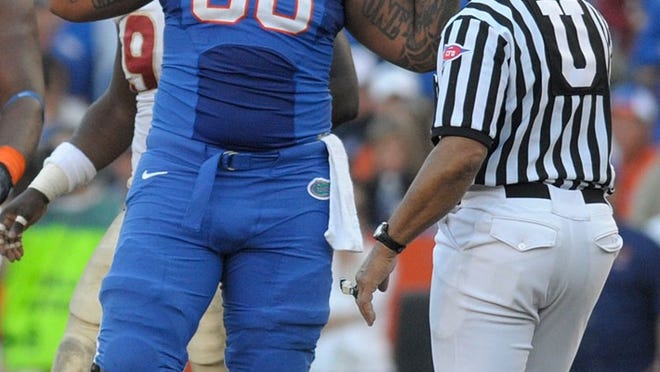 In this Nov. 28, 2009, photo, Florida center Maurkice Pouncey, left, argues a call with an official during an NCAA college football game against Florida State in Gainesville, Fla. Florida and the NCAA are investigating an allegation that Pouncey received $100,000 from a representative of a sports agent before last season ended, ESPN.com reported Monday, July 19. Pouncey was selected 18th overall in this year's NFL draft.