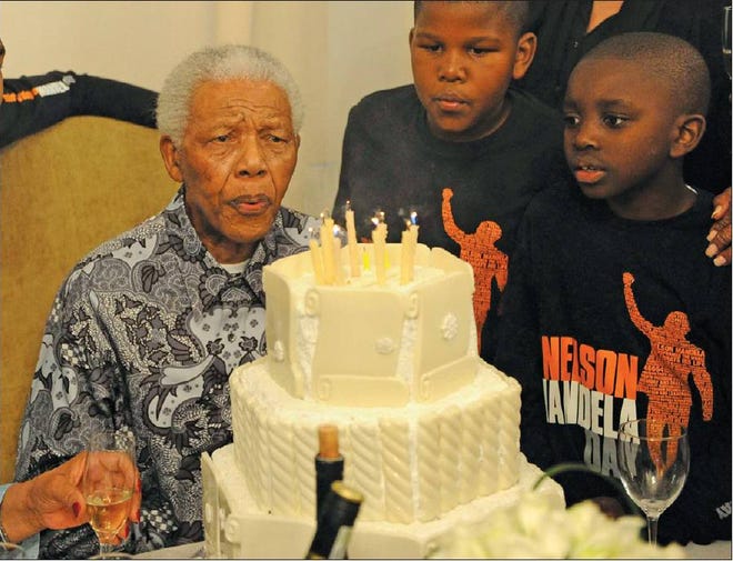 FAMILY TIME: Nelson Mandela blows out candles as he celebrates his birthday in Johannesburg on Sunday. Mandela, who turned 92 years old on Sunday, and is largely retired from public life, was spending the day with his family.
