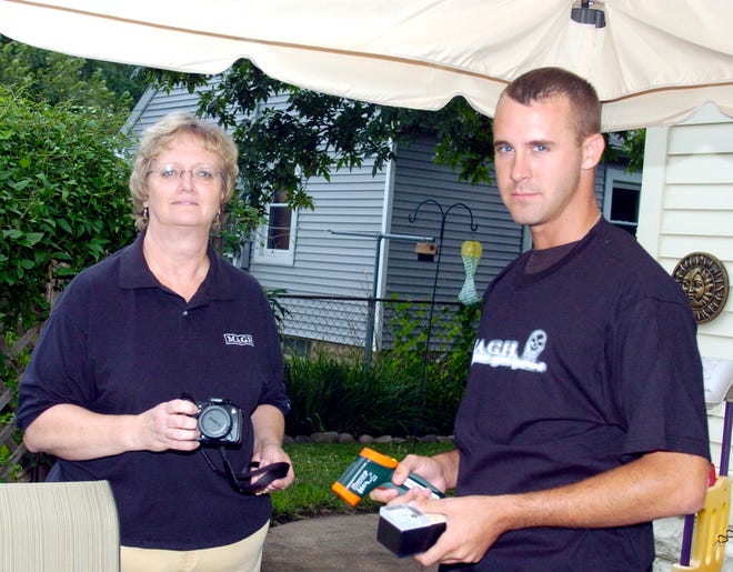 Mid America Ghost Hunters founder Anne Prichard of Pekin and team member Chris McCarthy hold some of the specialized digital equipment they use during investigations of paranormal activity in central Illinois.