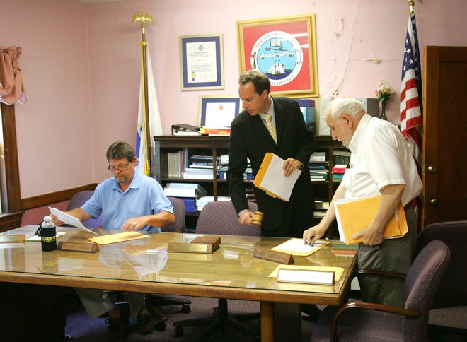 Members of the Weymouth Housing Authority Board of Commissioners, including from left Donald Sheehan, Victor Pap, and James Cunningham, rise to leave commissioner's chambers to meet in executive session on Tuesday, July 6, 2010, at the Housing Authority offices in Weymouth.
