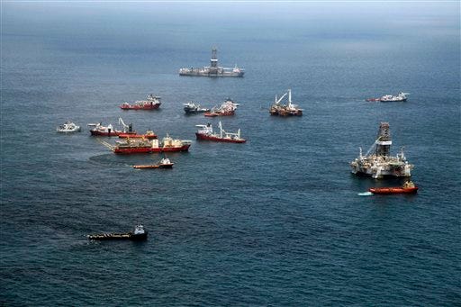 Vessels gather at the Deepwater Horizon oil spill site over the Gulf of Mexico, off the Louisiana coast, Tuesday, July 20, 2010. (Gerald Herbert/The Associated Press)