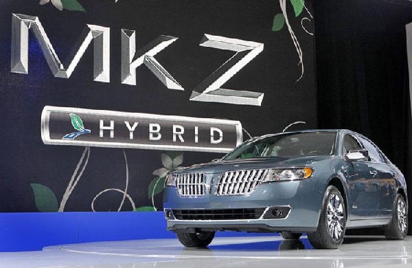 In this March 2010 photo, a new Lincoln MKZ Hybrid is unveiled at the New York International Auto Show in New York. Ford Motor Co. will soon have a first in the U.S. auto market: a hybrid sedan that costs the same as the gas-powered version.