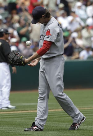 Red Sox pitcher Clay Buchholz reacts after giving up a home run to Jack Cust during Boston's 6-4 loss to the A's.